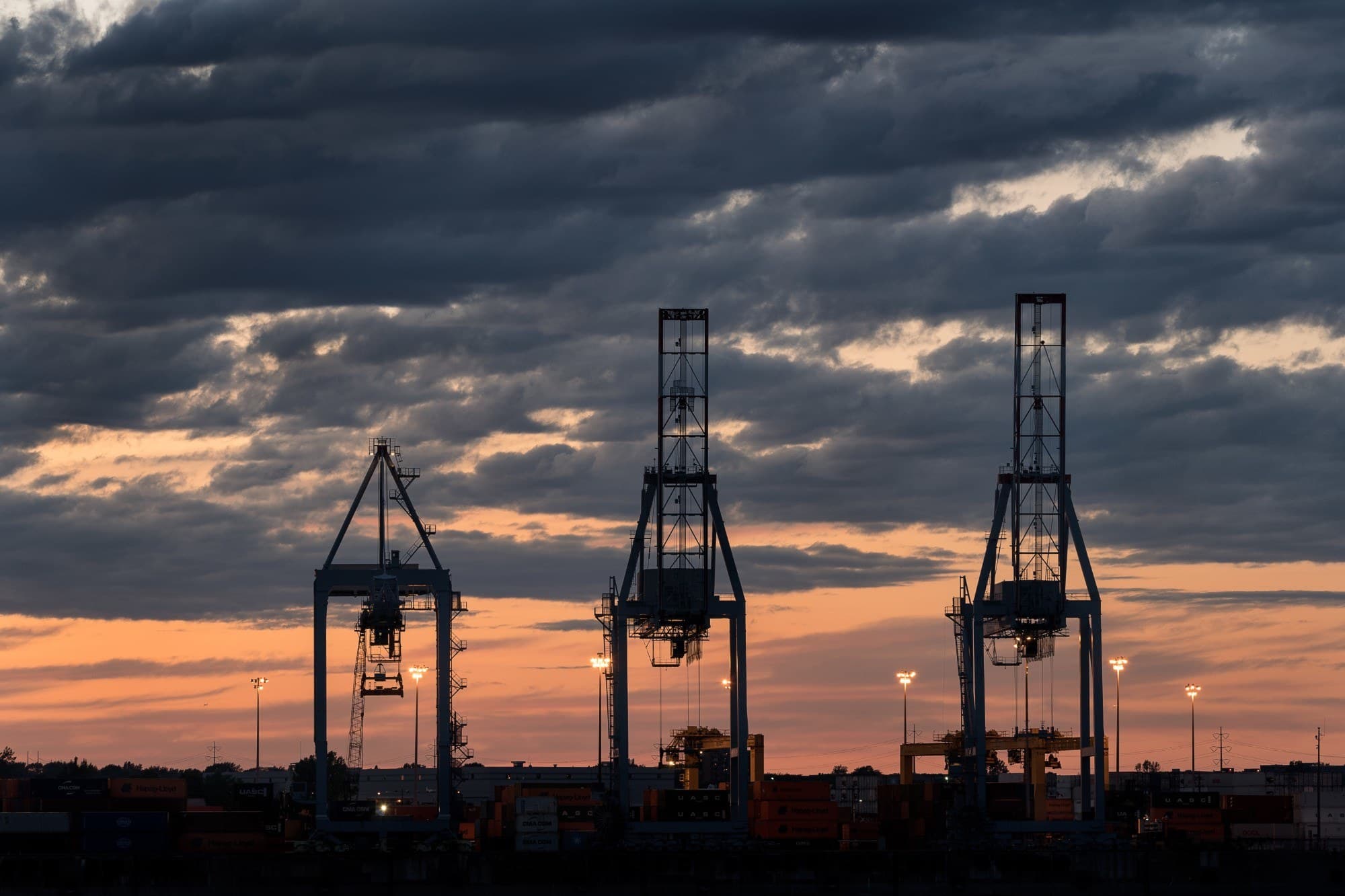 Silhouette of port container cranes at dusk